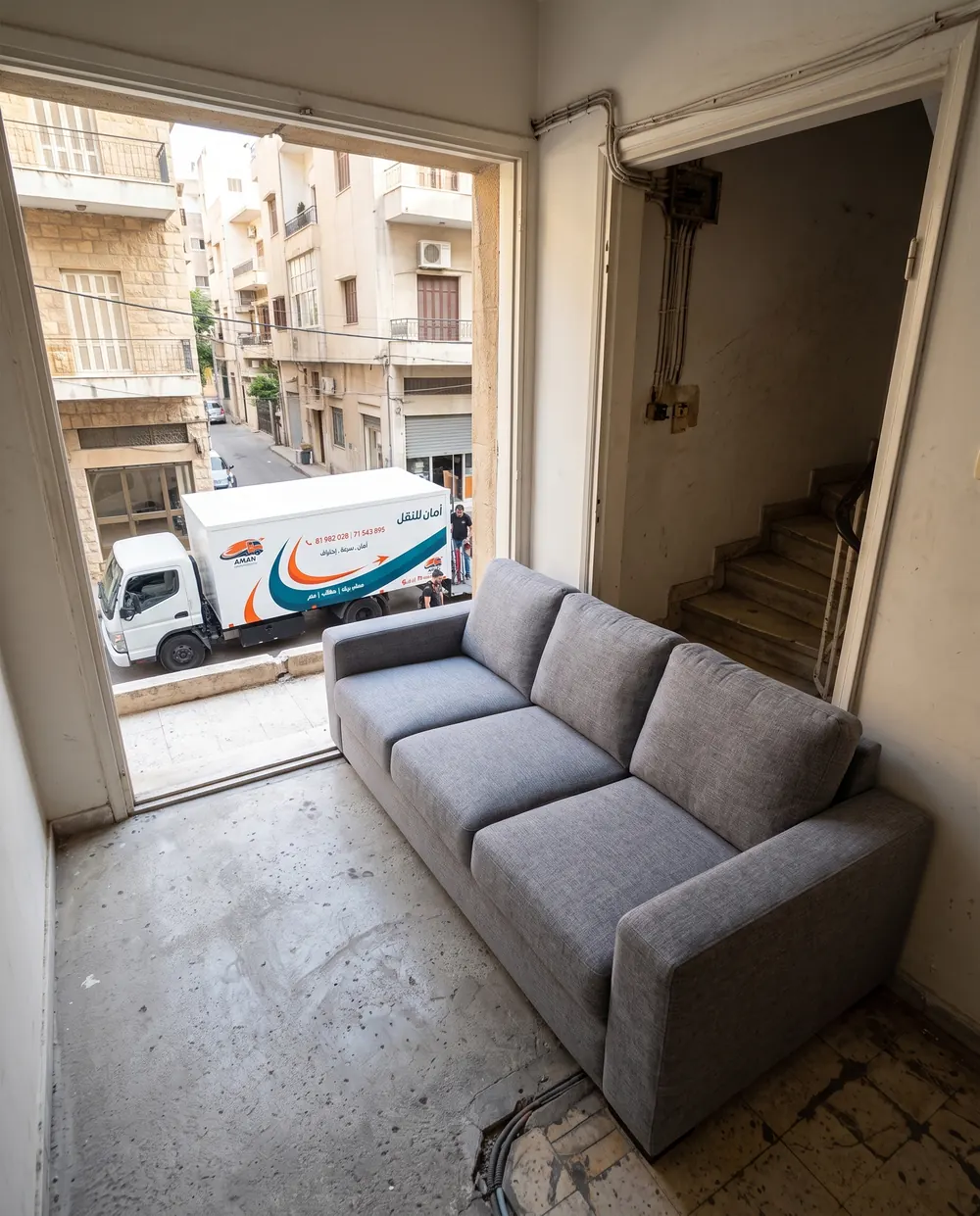 A sofa in the new home, AMAN truck outside