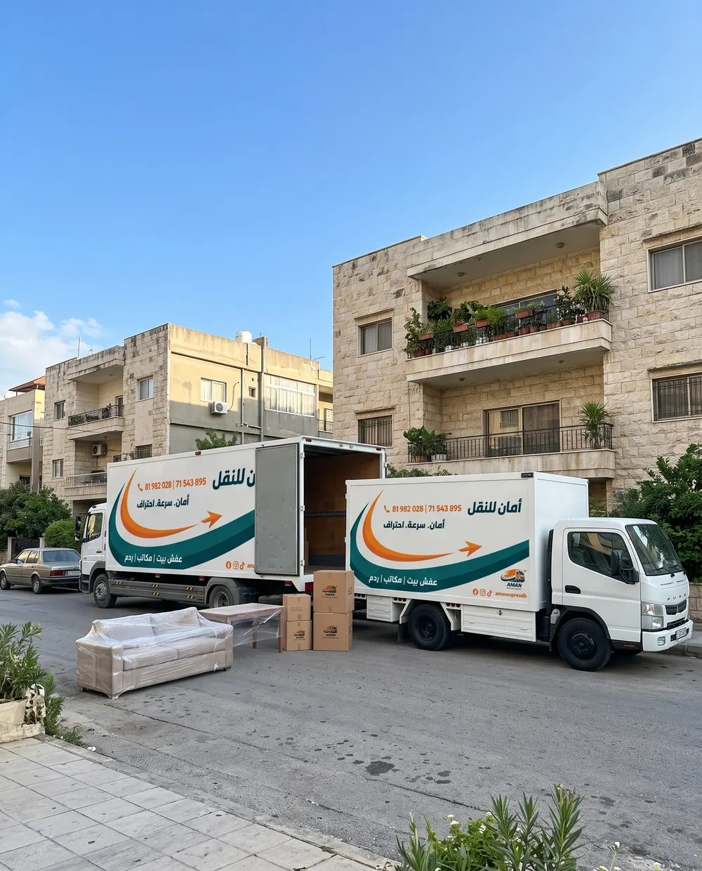 A wrapped sofa and two AMAN trucks